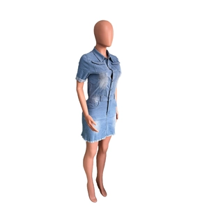 Detail view of light blue denim mini dress showing shirt collar and frayed raw hem design