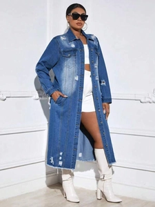 Detail of distressed long denim coat with ripped accents and faded wash finish
