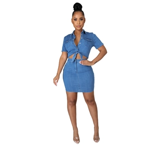 Detail of light blue denim two-piece set featuring a tie-knot shirt and slim-fit mini skirt