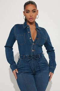 Close-up of deep blue denim jumpsuit with metal buttons and waist drawstring detail