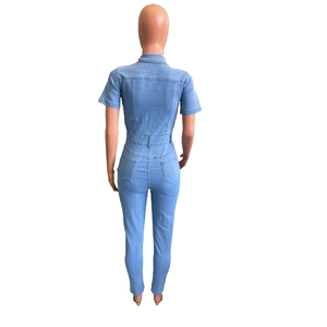Back view of light blue denim jumpsuit with short sleeves, belt and square pockets