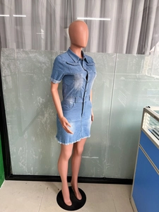 Detail of light blue denim mini dress showing side view, lapel collar, and frayed hemline