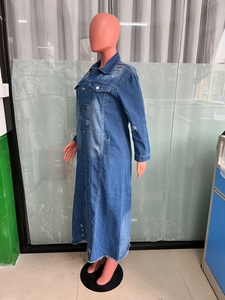 Detailed side view of long distressed denim trench coat with metal buttons and frayed hem