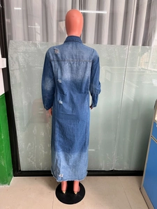 Detailed back view of long distressed denim jacket with ripped holes and washed finish