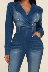 Detail of blue denim jumpsuit featuring double-breasted buttons and notched lapel