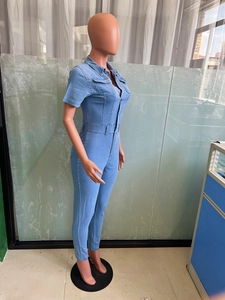 Side view detail of a slim fit light blue denim jumpsuit with buttoned pockets