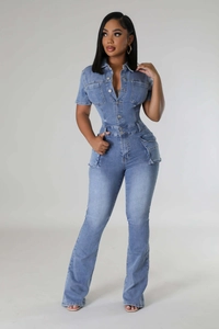 Detail view of light blue denim jumpsuit with slim waist and functional cargo pockets