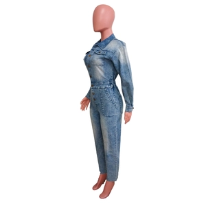 Detail of blue wash denim jumpsuit showing long sleeves and large functional side pockets