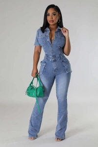 Detail view of washed blue denim jumpsuit with cargo pockets and slim fit waist design