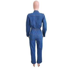 Detail of the back view showing elastic waist and patch pockets on denim jumpsuit