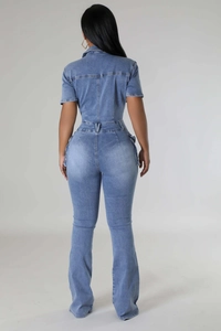 Slim fit denim jumpsuit with short sleeves and flared leg design shown from the back