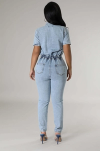 Back view of light blue denim jumpsuit with high waist, short sleeves and fitted back pockets