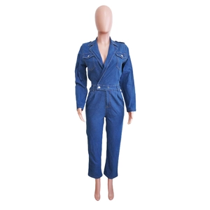 Detail of dark blue denim jumpsuit featuring long sleeves and notch lapel collar design