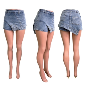 Detail view of light blue washed denim skort with asymmetrical front and back pockets