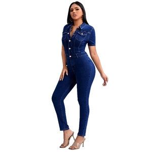 Detail of dark blue slim fit denim jumpsuit with short sleeves and white buttons