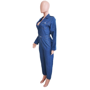 Detail of dark blue denim jumpsuit featuring lapel collar and chest pocket on dress form