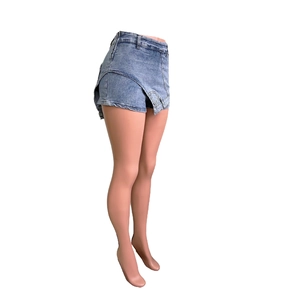 Detailed view of high waist blue washed denim skort with asymmetric layered design