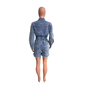 Back view of high stretch denim romper with distressed fringe hem and elastic waist