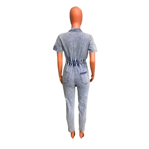 Rear view of slim fit denim jumpsuit with elastic waist and snow wash finish