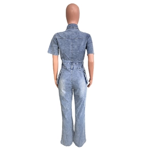 Detail view of washed light blue denim jumpsuit featuring cargo pockets and high waist