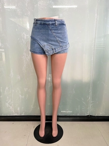 Detail of light blue denim mini skirt featuring unique asymmetrical layered deconstructed design