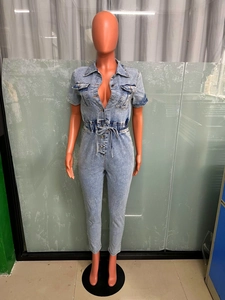 Detail view of light blue denim jumpsuit with elastic waist and drawstring cord