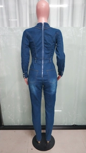 Rear view of slim fit denim jumpsuit featuring a full back zipper and square pockets