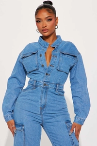 Détail macro de la taille élastique et du boutonnage sur la combinaison en jean bleu