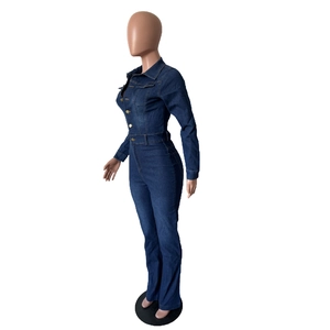 Detail of slim fit dark blue denim jumpsuit featuring long sleeves and metal buttons