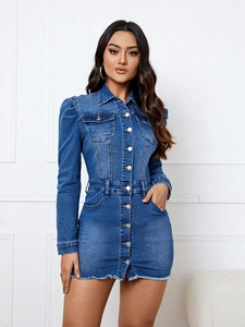 Close-up of a blue washed denim dress featuring puffy sleeves and frayed hem details