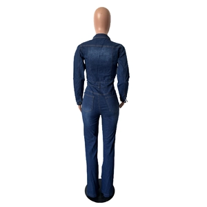 Detail view of the back pocket design and slimming fit of the blue denim jumpsuit