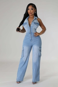 Detail of light blue denim jumpsuit with halter neck, front pockets and metal buttons