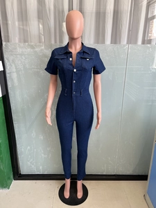 Detail view of dark blue denim jumpsuit featuring a button-down front and collar