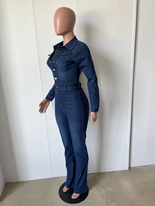 Detail of dark blue slim fit denim jumpsuit with long sleeves and gold buttons