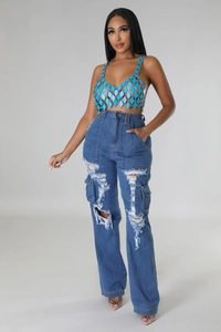 Close-up of high-waisted distressed denim jeans with large rips and side cargo pockets