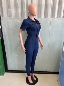 Detail view of slim fit dark blue denim jumpsuit with short sleeves on mannequin