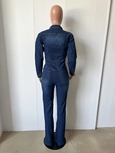 Back view detail of slim fit dark blue denim jumpsuit with pockets and washed finish