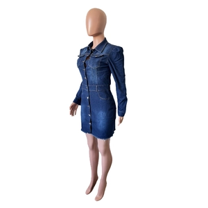 Close-up of a dark blue denim mini dress with buttons and frayed hem details