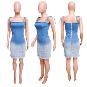 Detail view of the gradient blue denim dress featuring a slim fit and frayed hemline