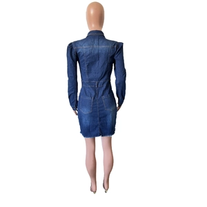 Detail view of denim jacket dress back featuring utility pockets and raw hemline finish