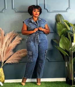 Detail of dark blue wash denim jumpsuit with drawstring waist and cargo side pockets