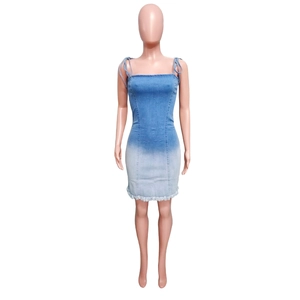 Detail of frayed hemline and blue gradient transition on a denim midi dress