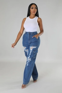 Detail of high-waist distressed jeans with large ripped holes and cargo style pockets