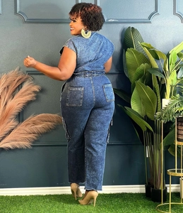 Detail view of denim jumpsuit back with elastic waist and large patch pockets