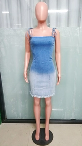 Detail of gradient blue denim dress featuring raw fringe hem and slim fit silhouette