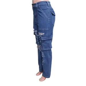 Detail view of large side cargo pocket and distressed ripped details on high waist denim jeans