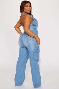 Close-up of light blue washed denim cargo jumpsuit with side pockets and slim fit