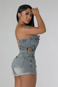 Side view of strapless denim romper with waist cut-outs and washed blue finish