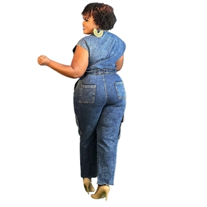 Rear view of denim jumpsuit with elastic waist, functional back pockets and raw hem detail