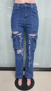 Detail of high-waisted distressed denim jeans featuring large cargo pockets and ripped knees